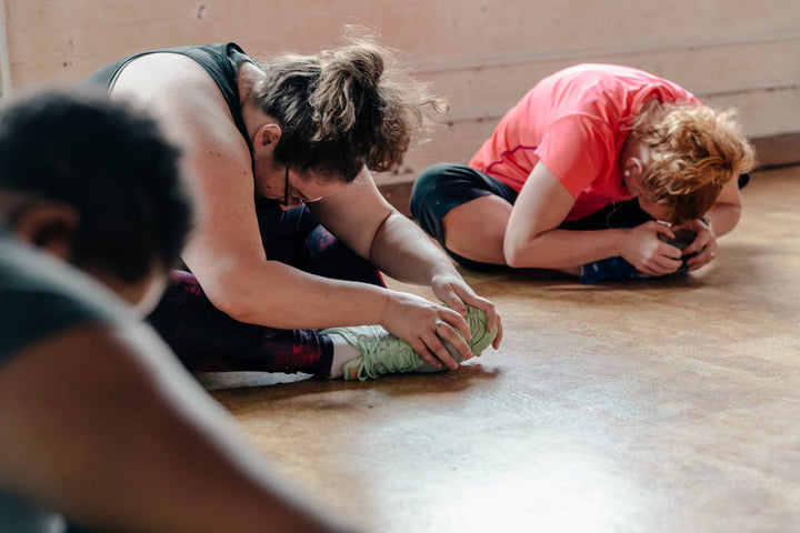 women-stretching-in-exercise-class